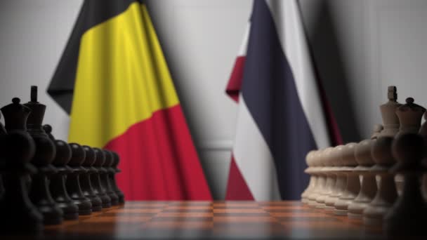 Vlaggen van België en Thailand achter pionnen op het schaakbord. Schaakspel of politieke rivaliteit gerelateerde 3D-animatie — Stockvideo