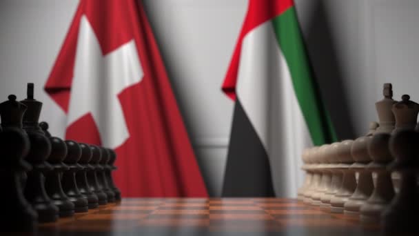 Bandiere della Svizzera e degli Emirati Arabi Uniti dietro pedoni sulla scacchiera. Gioco di scacchi o rivalità politica relativi animazione 3D — Video Stock