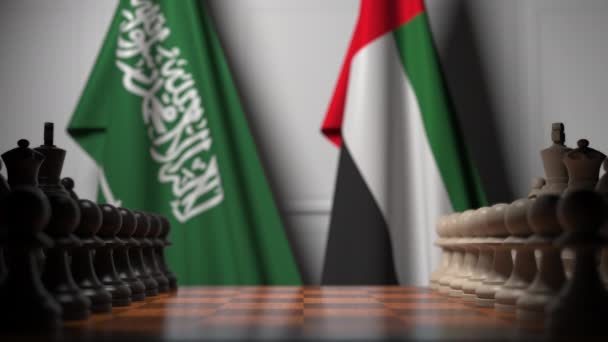 チェスボードのポーンの後ろにサウジアラビアとアラブ首長国連邦の旗。チェスゲームや政治的ライバル関連の3Dアニメーション — ストック動画