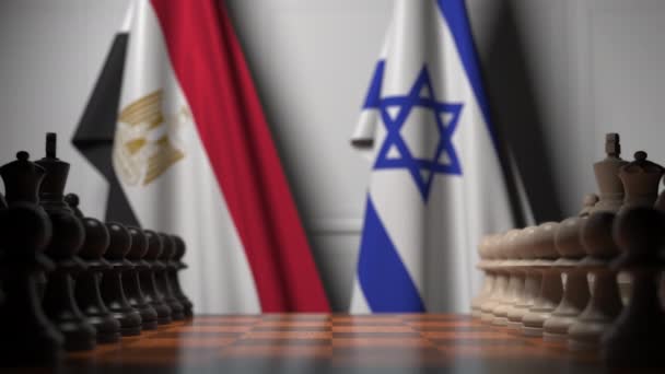 Флаги Египта и Израиля за пешками на шахматной доске. Шахматная игра или политическое соперничество — стоковое видео