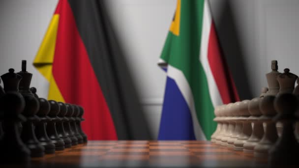 Bandeiras da Alemanha e África do Sul atrás de peões no tabuleiro de xadrez. Jogo de xadrez ou rivalidade política relacionada com animação 3D — Vídeo de Stock