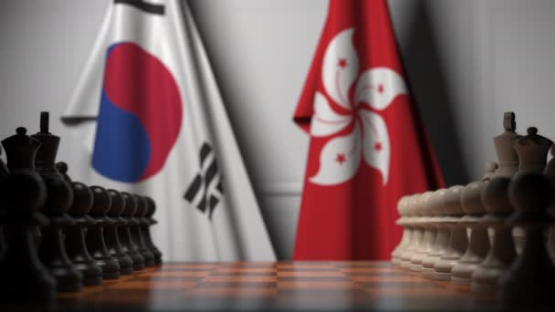 Bandiere della Corea del Sud e Hong Kong dietro pedine sulla scacchiera. Gioco di scacchi o rivalità politica relativi animazione 3D — Video Stock