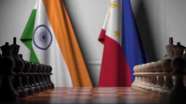 印度和菲律宾国旗在棋盘上的棋子后面。国际象棋游戏或政治竞争相关3D动画 — 图库视频影像