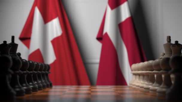 瑞士和丹麦国旗在棋盘上的棋子后面。国际象棋游戏或政治竞争相关3D动画 — 图库视频影像