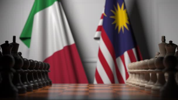 Flags of Italy and Malaysia behind pawns on the chessboard. Chess game or political rivalry related 3D animation — Stock Video