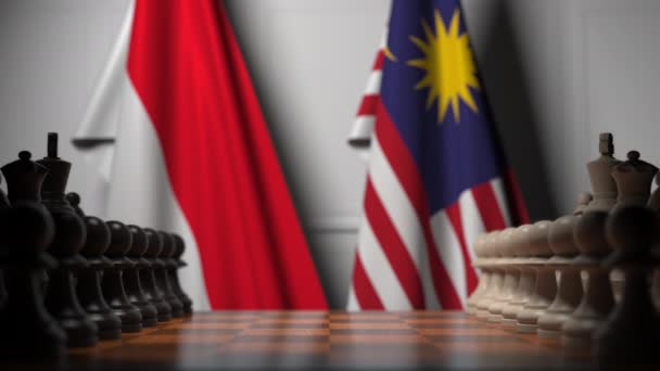 Banderas de Indonesia y Malasia detrás de peones en el tablero de ajedrez. Juego de ajedrez o rivalidad política relacionada con la animación 3D — Vídeos de Stock