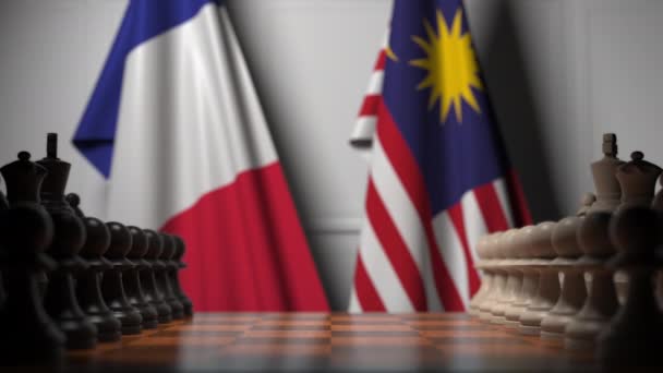 Flags of France and Malaysia behind pawns on the chessboard. Chess game or political rivalry related 3D animation — Stock Video