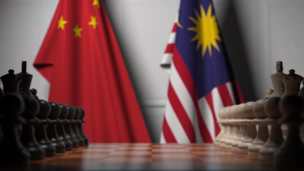 Flaggor i Kina och Malaysia bakom bönder på schackbrädet. Schack spel eller politisk rivalitet relaterade 3D-animering — Stockvideo
