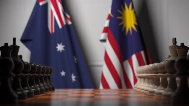 澳大利亚和马来西亚的旗帜在棋盘上的棋子后面。国际象棋游戏或政治竞争相关3D动画 — 图库视频影像