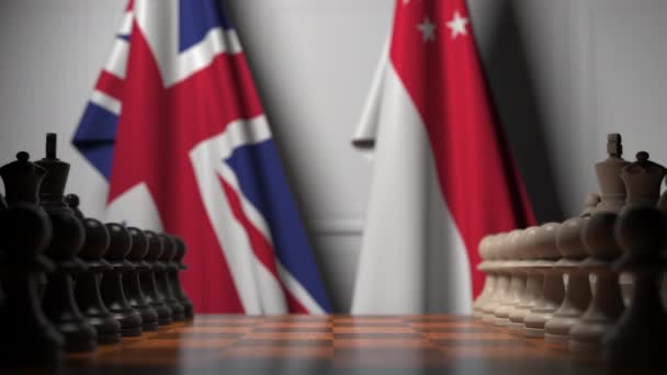 Flags of Great Britain and Singapore behind pawns on the chessboard. Chess game or political rivalry related 3D animation — Stock Video