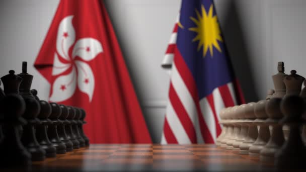 Flaggor av Hong Kong och Malaysia bakom brickor på schackbrädet. Schack spel eller politisk rivalitet relaterade 3D-animering — Stockvideo