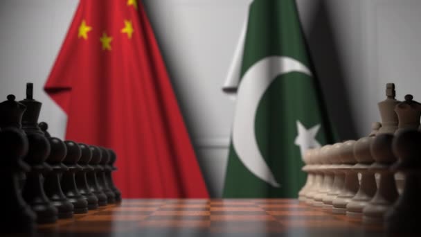 チェスボードのポーンの後ろに中国とパキスタンの旗。チェスゲームや政治的ライバル関連の3Dアニメーション — ストック動画