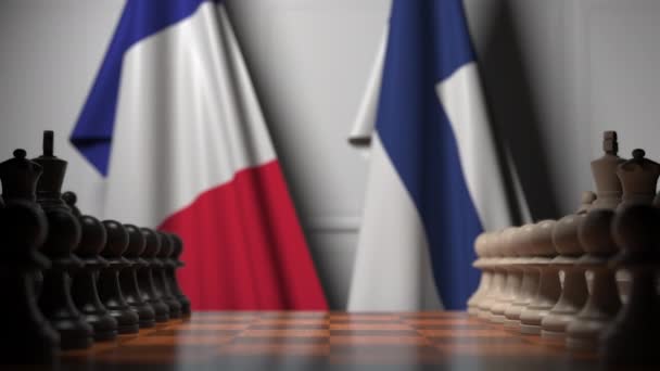 Флаги Франции и Финляндии за пешками на шахматной доске. Шахматная игра или политическое соперничество — стоковое видео