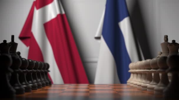 Banderas de Dinamarca y Finlandia detrás de peones en el tablero de ajedrez. Juego de ajedrez o rivalidad política relacionada con la animación 3D — Vídeo de stock