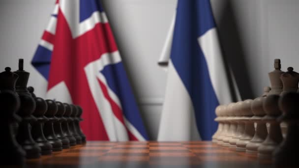 Nagy-Britannia és Finnország zászlói mögött a sakktáblán. Sakk-játék vagy politikai rivalizálás 3D animáció — Stock videók