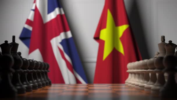 Förenade kungarikets och Vietnams flaggor bakom brickor på schackbrädet. Schackspel eller politisk rivalitet relaterad 3D-animation — Stockvideo