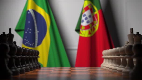 Флаги Бразилии и Португалии за пешками на шахматной доске. Шахматная игра или политическое соперничество — стоковое видео