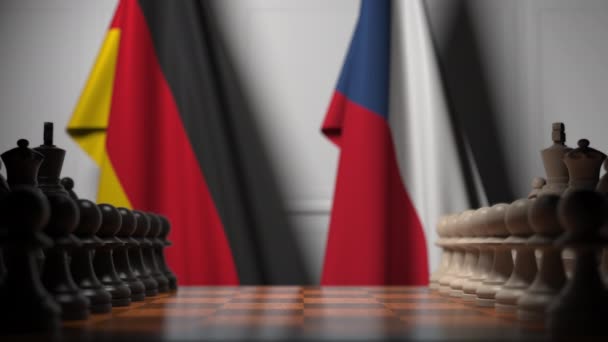 Drapeaux de l'Allemagne et de la République tchèque derrière pions sur l'échiquier. Jeu d'échecs ou rivalité politique liée à l'animation 3D — Video