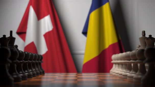Drapeaux de la Suisse et de la Roumanie derrière pions sur l'échiquier. Jeu d'échecs ou rivalité politique liée à l'animation 3D — Video