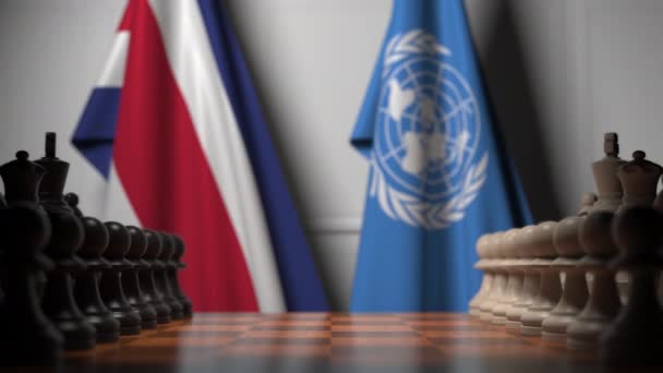 Vlajky Kostariky a OSN za pěšáky na šachovnici. Koncepční redakční 3D animace — Stock video