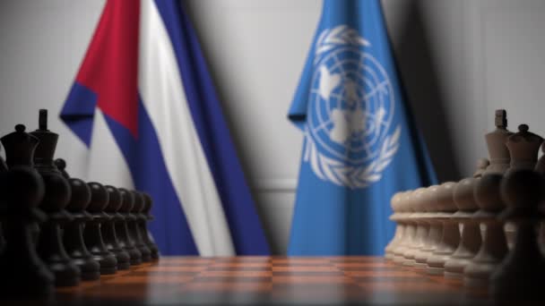 Flags of Cuba and United Nations behind pawns on the chessboard. Conceptual editorial 3D animation — Stock Video