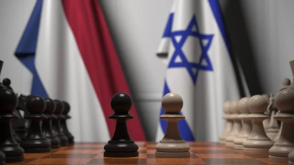 Drapeaux des Pays-Bas et d'Israël derrière des pions sur l'échiquier. Jeu d'échecs ou rivalité politique liée au rendu 3D — Photo