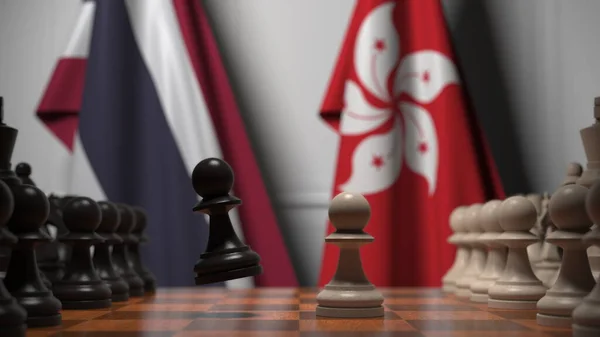 Флаги Таиланда и Гонконга за пешками на шахматной доске. Шахматная игра или политическое соперничество — стоковое фото