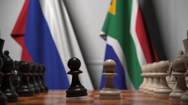 Drapeaux de la Russie et de l'Afrique du Sud derrière pions sur l'échiquier. Jeu d'échecs ou rivalité politique liée au rendu 3D — Photo