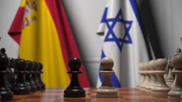 Drapeaux d'Espagne et d'Israël derrière des pions sur l'échiquier. Jeu d'échecs ou rivalité politique liée au rendu 3D — Photo