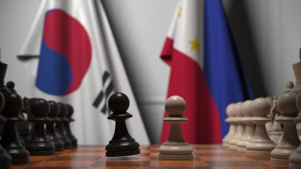 Bandeiras da Coreia e Filipinas atrás de peões no tabuleiro de xadrez. Jogo de xadrez ou rivalidade política relacionada com a renderização 3D — Fotografia de Stock