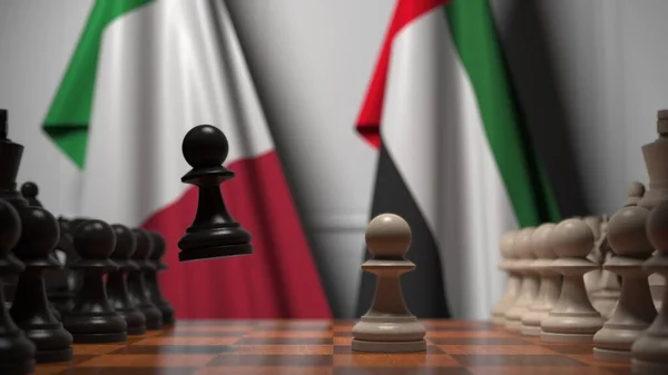 Флаги Италии и ОАЭ за пешками на шахматной доске. Шахматная игра или политическое соперничество — стоковое фото