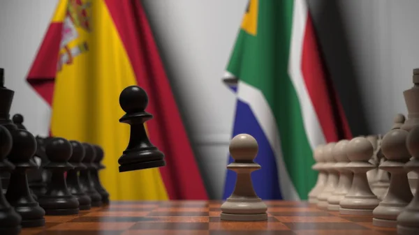 Spanyol és dél-afrikai zászlók gyalogok mögött a sakktáblán. Sakk játék vagy politikai rivalizálás kapcsolódó 3d renderelés — Stock Fotó