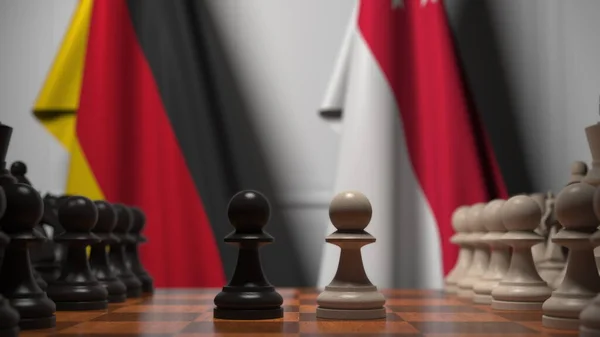 Flags of Germany and Singapore behind pawns on the chessboard. Chess game or political rivalry related 3D rendering — Stock Photo, Image