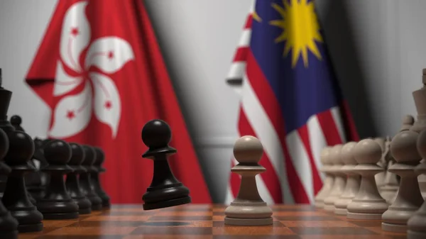 Hongkongs och Malaysias flaggor bakom brickor på schackbrädet. Schackspel eller politisk rivalitet relaterad till 3D-rendering — Stockfoto