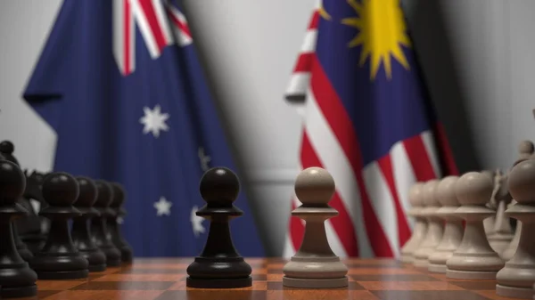 チェスボード上の質屋の後ろのオーストラリアとマレーシアの旗。チェスゲームや政治的ライバル関係の3Dレンダリング — ストック写真