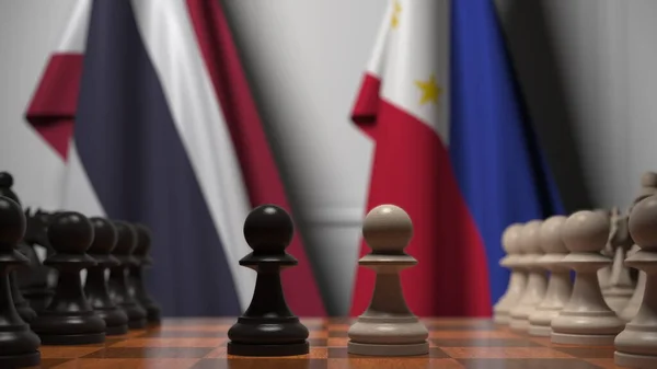 타이와 필리핀의 국기가 체스 판의 졸 뒤에 걸려 있습니다. 체스 게임이나 정치적 라이벌은 3D 렌더링 과 관련 이 있다. — 스톡 사진