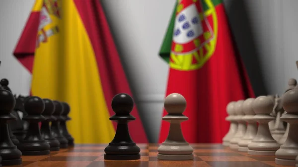 Satranç tahtasındaki piyonların arkasında İspanya ve Portekiz bayrakları. Satranç ya da siyasi çekişme ile ilgili 3 boyutlu yorumlama — Stok fotoğraf