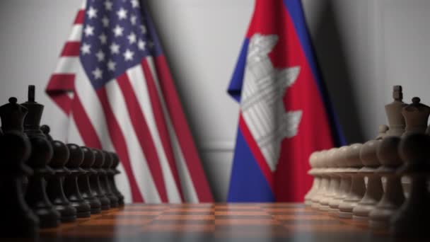 Флаги США и Камбоджи за пешками на шахматной доске. Шахматная игра или политическое соперничество — стоковое видео