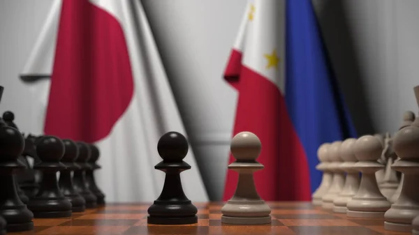 チェス盤には日本とフィリピンの国旗が描かれている。チェスゲームや政治的ライバル関係の3Dレンダリング — ストック写真