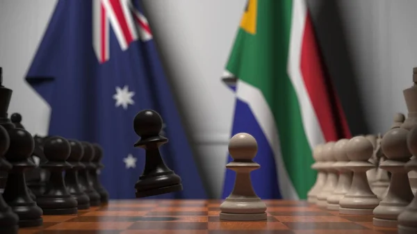 チェス盤の質屋の後ろのオーストラリアと南アフリカの旗。チェスゲームや政治的ライバル関係の3Dレンダリング — ストック写真