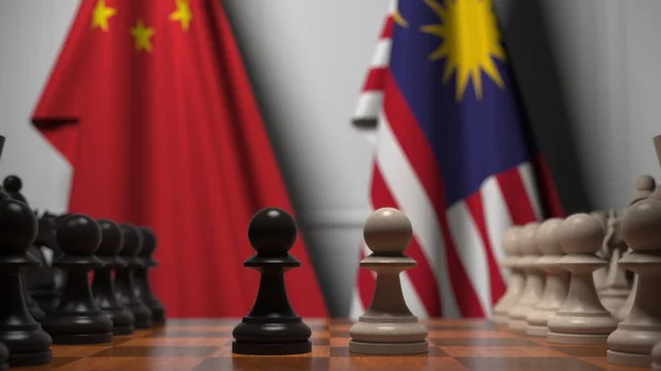 Flaggor av Kina och Malaysia bakom brickor på schackbrädet. Schackspel eller politisk rivalitet relaterad till 3D-rendering — Stockfoto