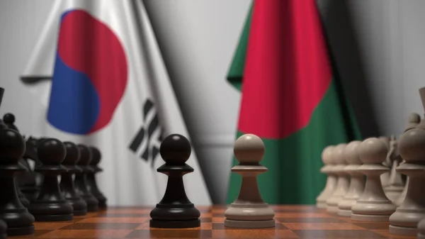 Drapeaux de la Corée du Sud et du Bangladesh derrière des pions sur l'échiquier. Jeu d'échecs ou rivalité politique liée au rendu 3D — Photo