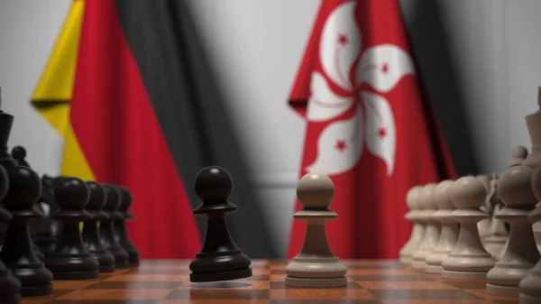 체스 판의 졸 뒤에 있는 독일 과 홍콩의 깃발이었습니다. 체스 게임이나 정치적 라이벌은 3D 렌더링 과 관련 이 있다. — 스톡 사진