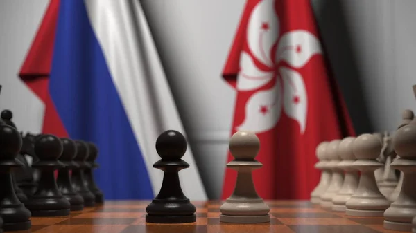 Orosz és hongkongi zászlók gyalogok mögött a sakktáblán. Sakk játék vagy politikai rivalizálás kapcsolódó 3d renderelés — Stock Fotó