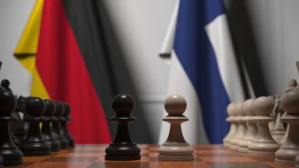 チェスボード上の質屋の後ろにドイツとフィンランドの旗。チェスゲームや政治的ライバル関係の3Dレンダリング — ストック写真