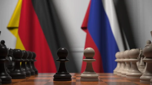 Schachspiel gegen Flaggen von Deutschland und Russland. 3D-Darstellung — Stockfoto