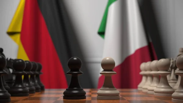 Шахматная игра против флагов Германии и Италии. Политическая конкуренция — стоковое фото