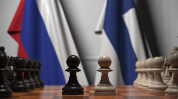 チェスボード上の質屋の後ろのロシアとフィンランドの旗。チェスゲームや政治的ライバル関係の3Dレンダリング — ストック写真