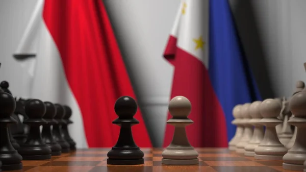인도네시아와 필리핀의 국기가 체스 판의 졸 뒤에 걸려 있습니다. 체스 게임이나 정치적 라이벌은 3D 렌더링 과 관련 이 있다. — 스톡 사진
