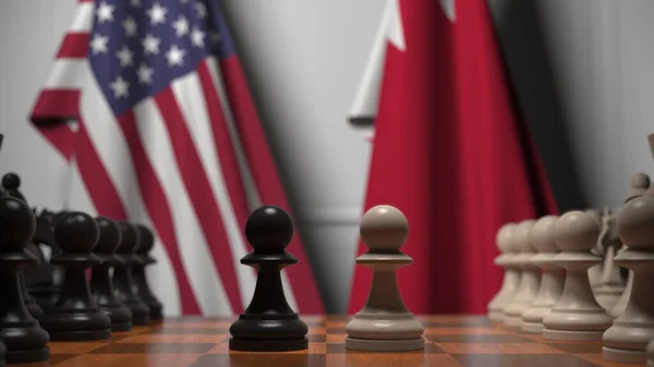 Banderas de EE.UU. y Bahréin detrás de peones en el tablero de ajedrez. Juego de ajedrez o rivalidad política relacionada con la representación 3D — Foto de Stock